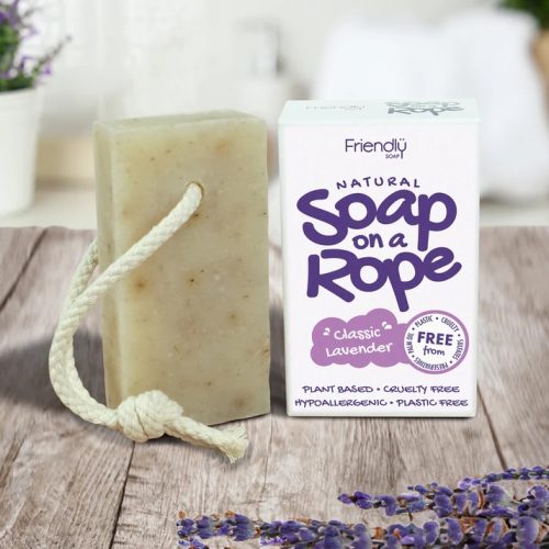 Friendly Soap Lavender natural Soap on a Rope. Pictured with a white piece of rope through the soap bar, standing next to its white box packaging with purple text